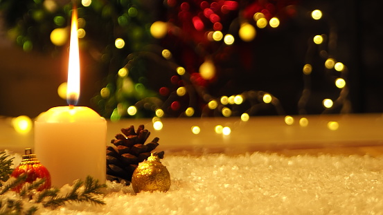 Two Christmas Candles with Golden Decoration. Selective Focus