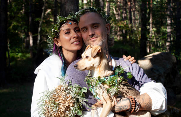 The bride and the groom pose with their dog during their Celtic wedding photoshoot. They got married in the idilic Lago Delle Lame (Lake Lame) in the Italian region of Liguria. Photo taken on September 16, 2022