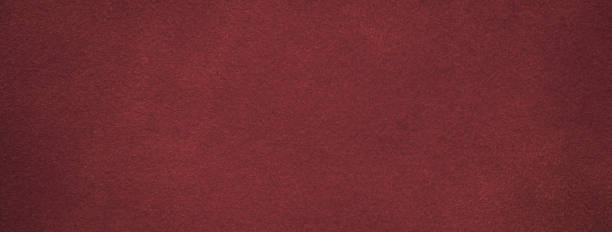 istock Texture of dark red velvet matte background, macro. Suede wine fabric with pattern. Seamless textile leather backdrop, 1447951754