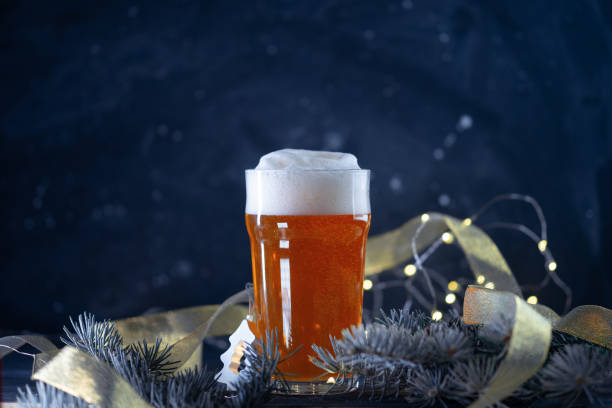 istock glass of light beer on a Christmas background 1447952093