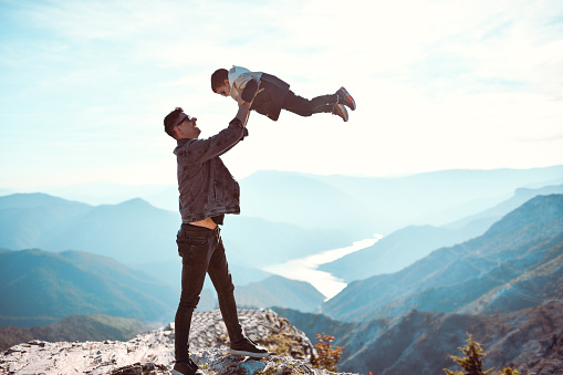 Father Playing With Child Son And Lifting Him Up High