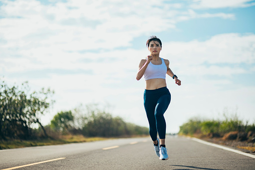 Asian female athlete on solitary training run