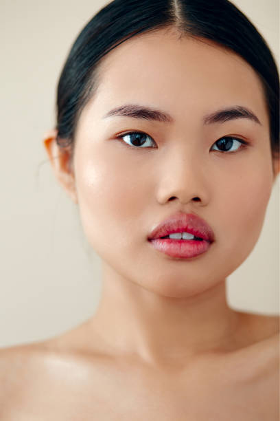 istock Beautiful Asian Woman With Posing In Studio Over Beige Background. 1447955149