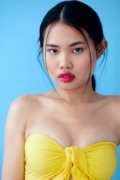 istock Beautiful Asian Woman Posing In Studio Over Blue Background. 1447955305