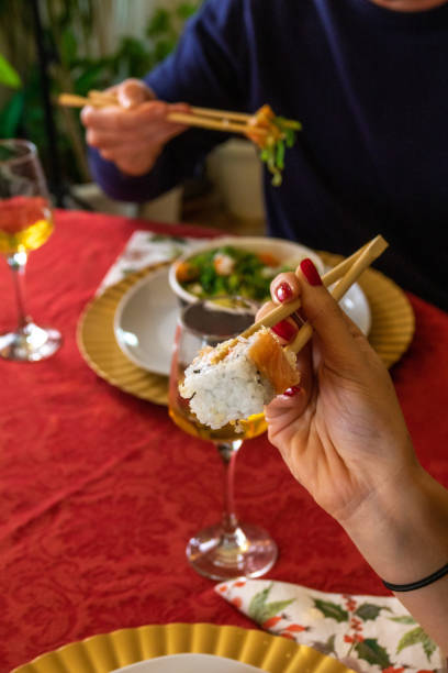 istock Eating sushi at christmas on the table with chopsticks 1447957566