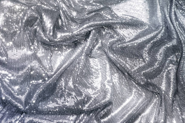 istock Fabric decorated with silver sequins, draped, holiday concept. 1447958311