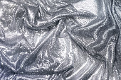 Fabric decorated with silver sequins, draped, holiday concept.