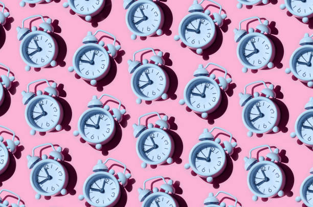 istock Seamless pattern of white alarm clocks on pink background 1447958833