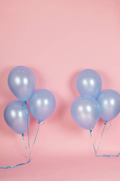 istock A pink backdrop with blue purple lavender balloons for a backdrop birthday celebration 1447959029