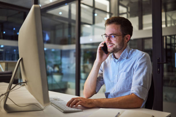 istock Phone call, night office and computer businessman talking, communication and discussion for networking, planning deal and vision. Male employee mobile conversation, desktop and ideas in dark company 1447959063