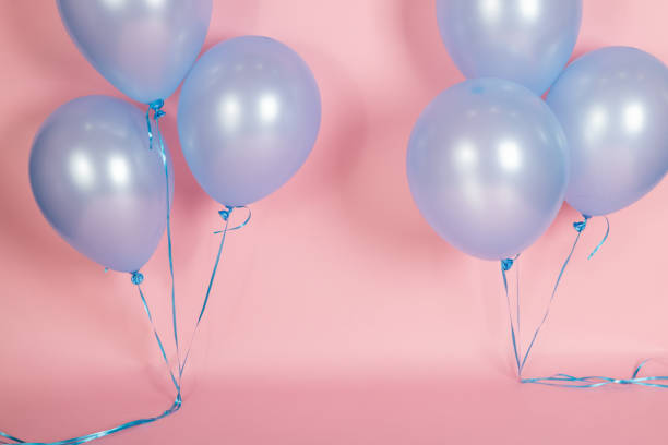 istock A pink backdrop with blue purple lavender balloons for a backdrop birthday celebration 1447959103
