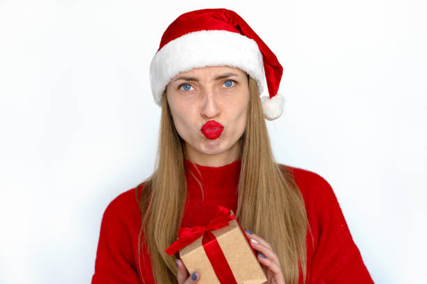 istock Smiling girl is holding a Christmas present. 1447959170
