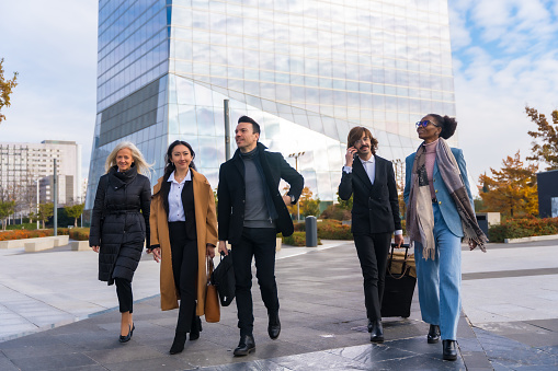 Group of multi-ethnic business people, business park, coworkers, walking to work