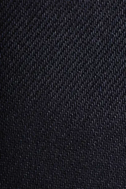 Close up shot of a blue colored jeans texture background.