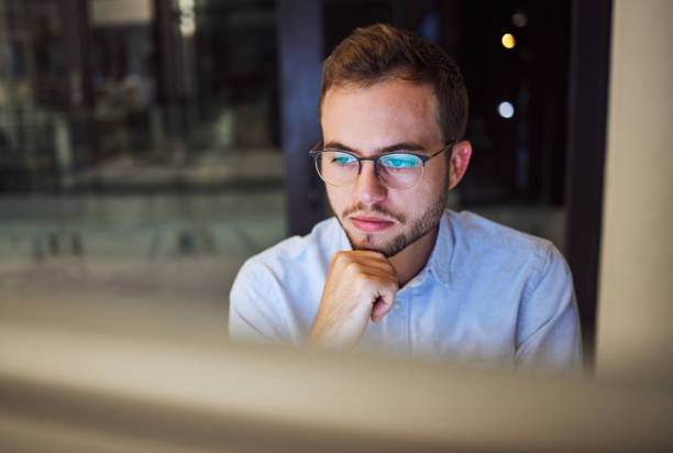 istock Businessman, computer and office thinking at night planning trading strategy for financial market at finance company. Canada online trader person focus, working or reading pc corporate fintech email 1447960187
