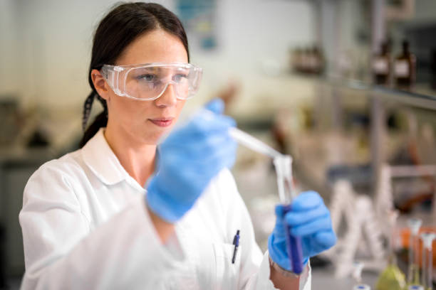 istock Female technician in a laboratory working with a pipette during an experiment 1447960662