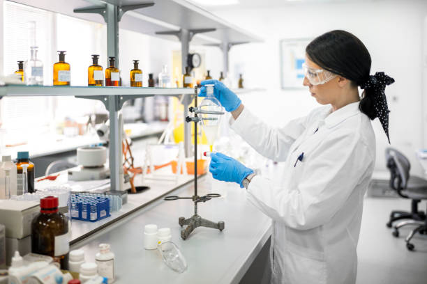 istock Female technician in a laboratory working with a pipette during an experiment 1447960741