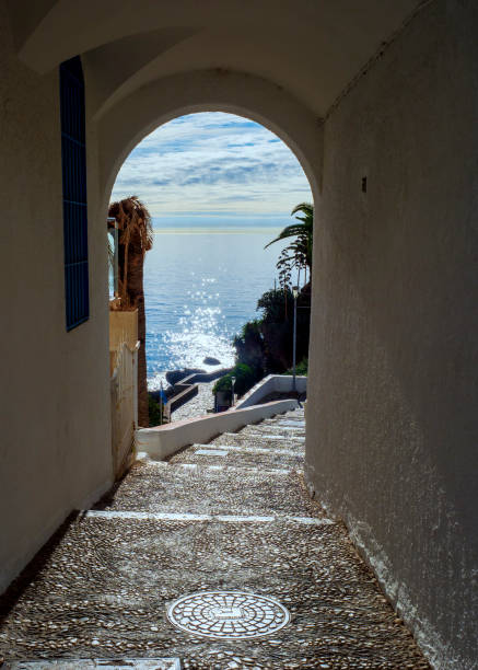 Arch on the way to the sea Street with an arch on the way to the sea in Nerja nerja stock pictures, royalty-free photos & images