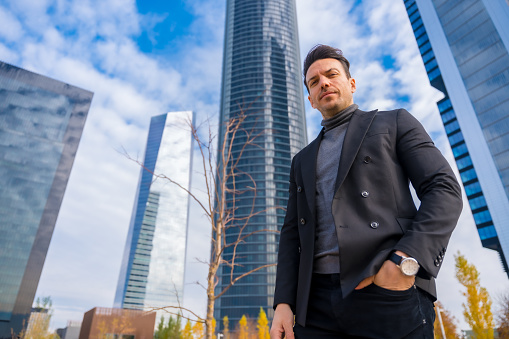 Corporate portrait of middle-aged businessman, business park with glass skyscrapers