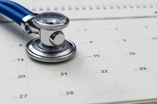 istock Stethoscope and pen on a calendar 1447963075