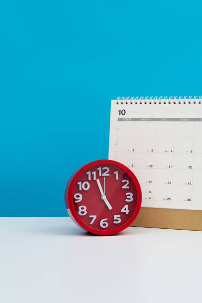 Calendar and alarm clock on the table