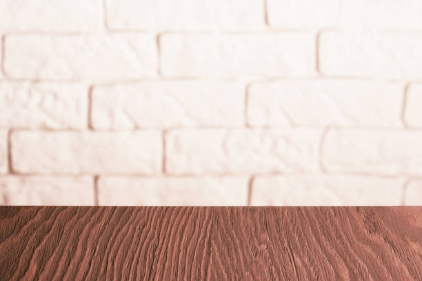 istock Wooden table display template with white brick walls on the back 1447964134