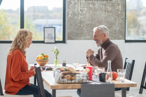 istock Mature couple sitting at the table and having dinner 1447964820