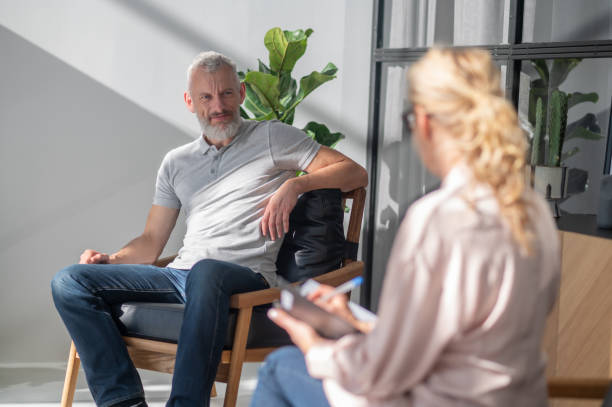 istock Man talking to a blonde woman and looking involved 1447965030