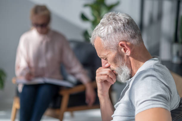 istock Mature amn looking stressed while having a conversation with a psychilogist 1447965109