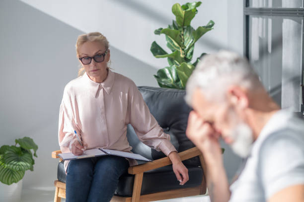 istock Mature amn looking stressed while having a conversation with a psychilogist 1447965111
