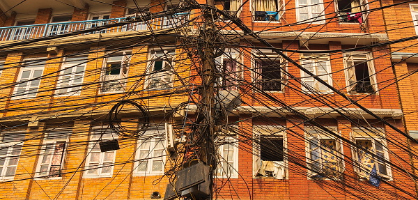 Messy cables in front of residential buildings in Lalitpur (or Patan), Kathmandu valley, Nepal