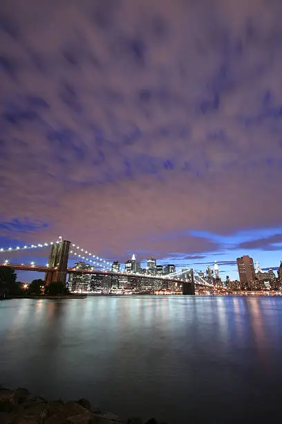 Photo of Manhattan skyline and Brooklyn Bridge at twilight