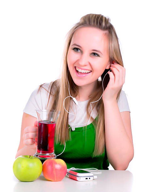 girl listening music and holding juice stock photo