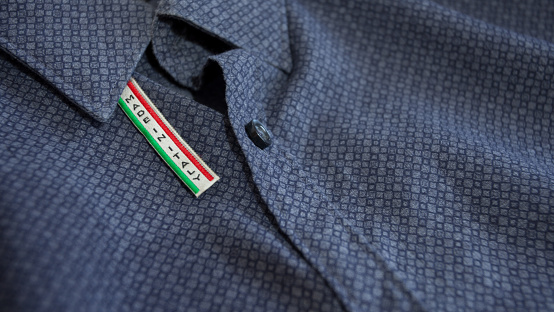 Made in Italy label on blue cotton shirt