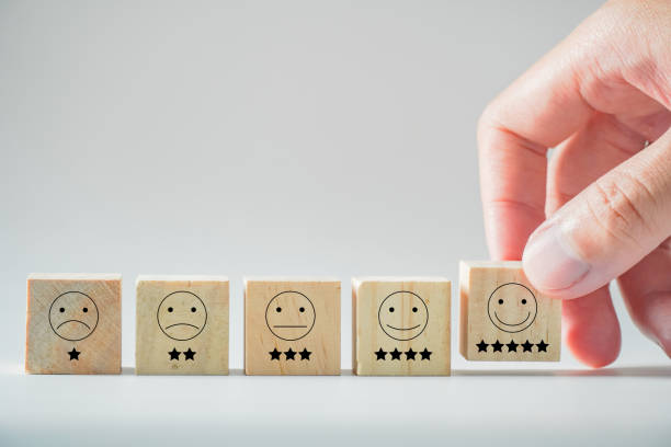 istock customer review good rating concept hand pressing smile face icon and five star on visual screen for positive customer feedback. 1447969016
