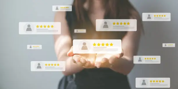 Photo of Business people using smartphone and pressing review popup on visual screen, customer review by five star feedback, positive customer feedback testimonial.