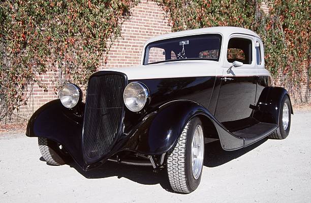 Ford five window coupe 1933 or 34 five window coupe painted black and grey parked in front of an ivy covered brick wall 1934 stock pictures, royalty-free photos & images