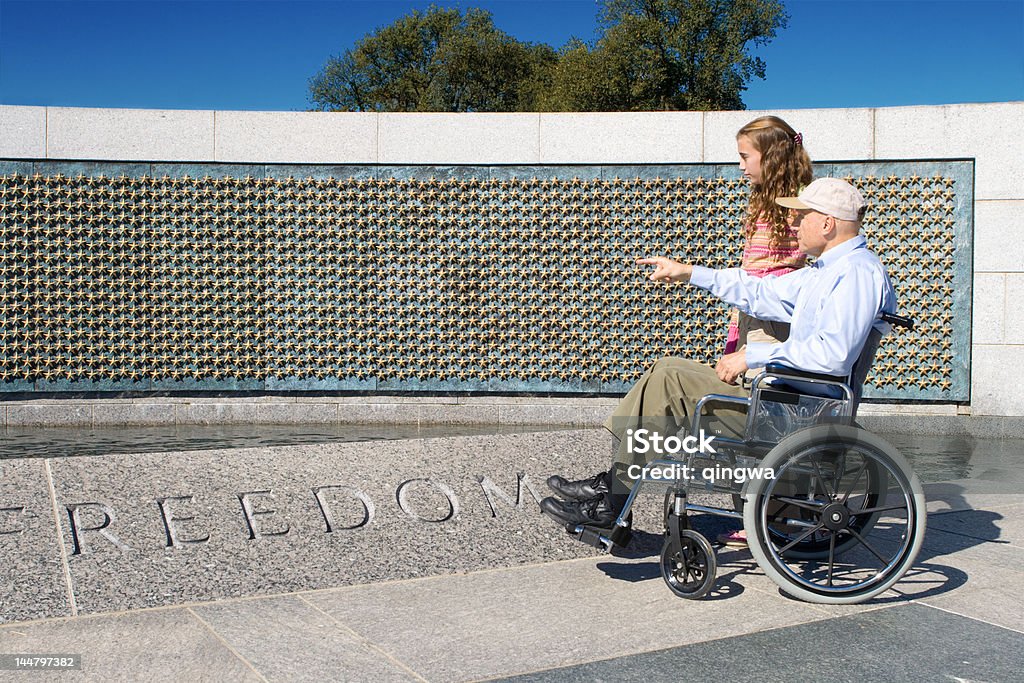 Grandfather in Wheelchair and Granddaughter at World War II Memorial Older man in a wheelchair and his grand daughter looking at the stars of the fallen at the World War II Memorial in Washington, DC. - See lightbox for more Veteran Stock Photo