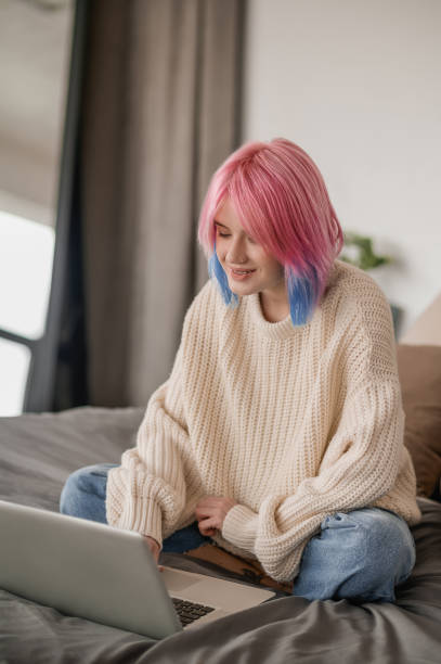 istock Contented female freelancer working on the laptop 1447974492
