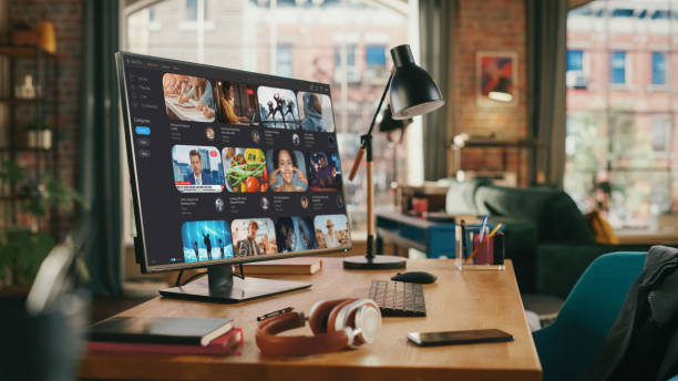 istock Desktop Personal Computer With Online Streaming Service On High Resolution Monitor. Work Space of Creative Proffesional in Stylish Empty Loft Apartment. Urban City View from Big Window. 1447977563