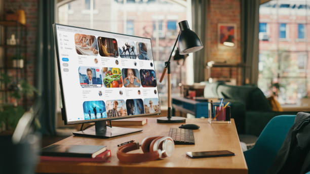 istock Desktop Personal Computer With Online Streaming Service On High Resolution Monitor. Work Space of Creative Proffesional in Stylish Empty Loft Apartment. Urban City View from Big Window. 1447977584