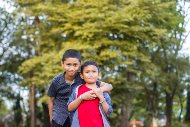 istock two boys joking and playing in the park 1447977966