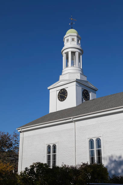 istock Church with tower clock against a blue sky 1447978257