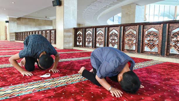 istock Muslim boys salat in the mosque 1447979607