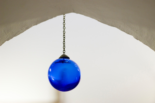 detail of a spheric blue lamp hanging of the ceiling