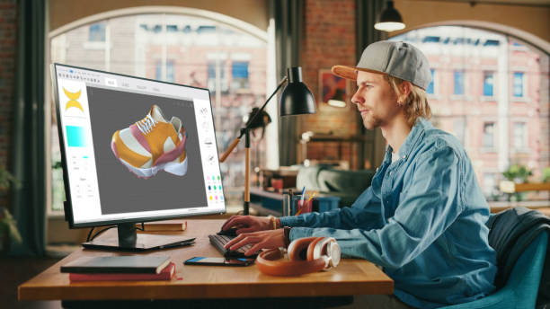 istock Caucasian Man Design Video Game at His Personal Computer in a Creative Office. Man Designing Clothing For Charachter on His Desktop Computer. Game with Graphics and Social Media Metaverse Gameplay. 1447980095