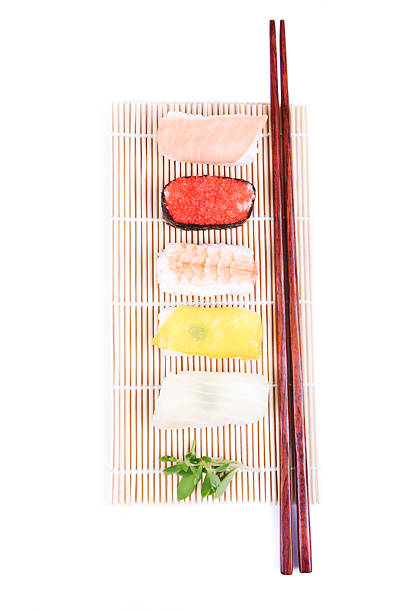 istock Sushi, green and chopsticks on bamboo mat 144798378