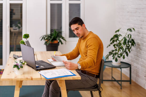 istock A handsome young man is working for a home office during the pandemic time. 1447984336