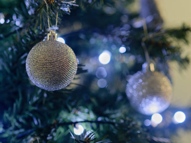istock Selective focus shot of a silver Christmas tree ball on a Christmas tree 1447985189