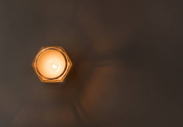 istock Burning candle on the table with glow of light. view from above 1447985788